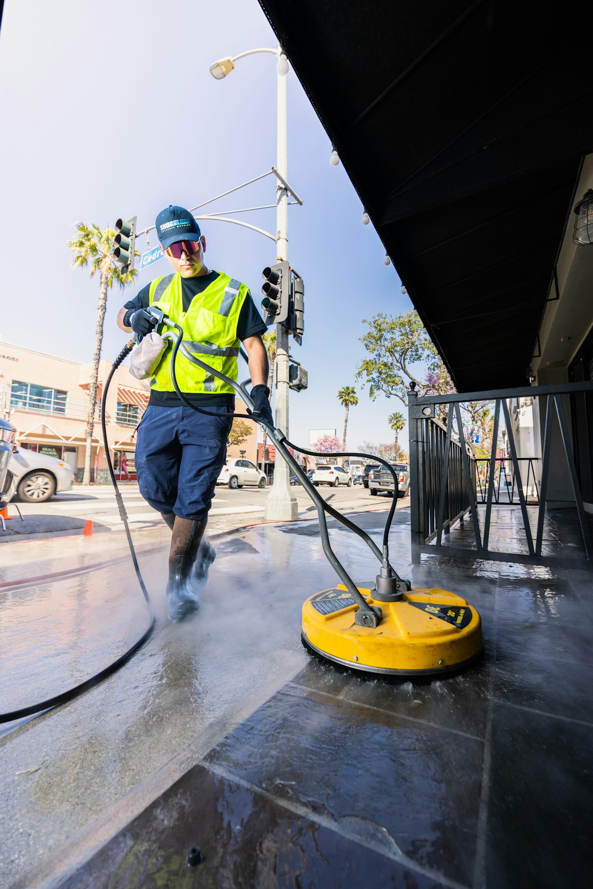 ClearVue technician pressure washing a commercial sidewalk